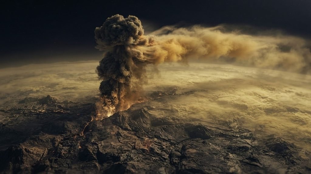 Active Venus volcanism showing a massive planetary eruption with turbulent volcanic gas clouds bending horizontally under heavy lower-atmosphere winds across a dark space background.
